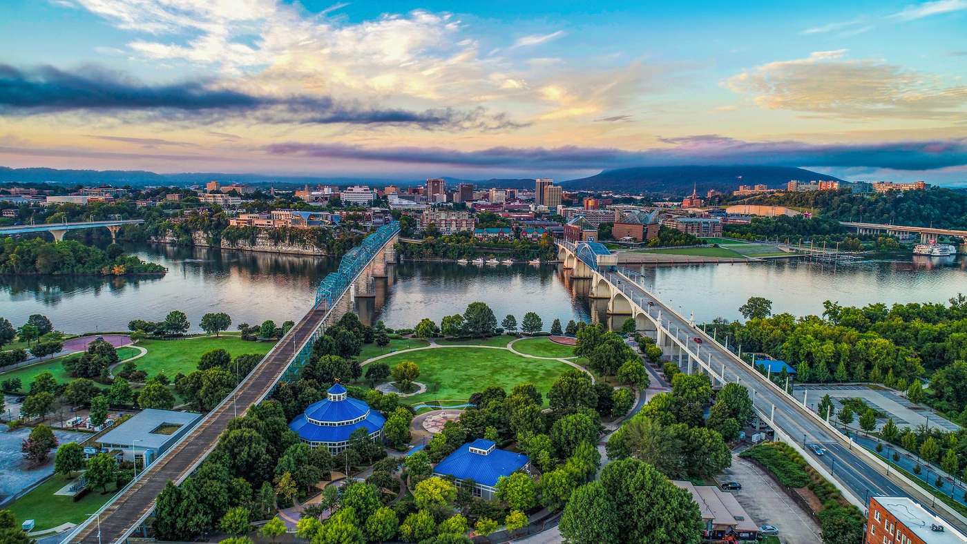 Aerial view of downtown Chattanooga at golden hour, with the Tennessee River and the bridges