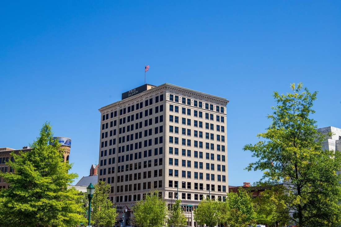 The Volunteer Building tower in downtown Chattanooga, with trees against a clear sky