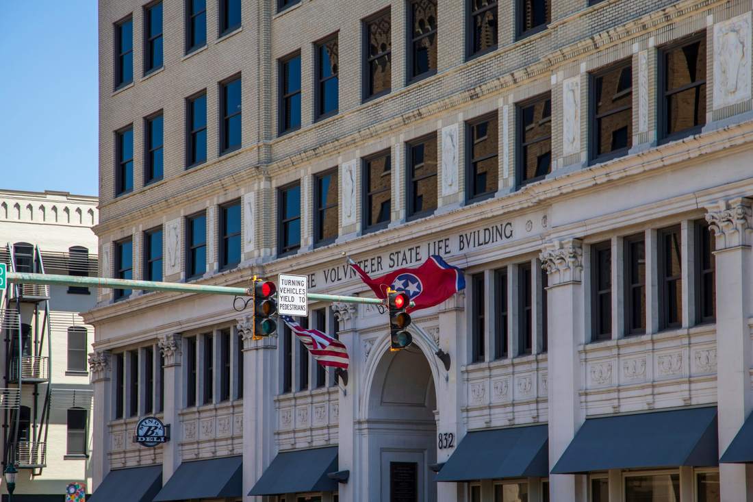 Facade of the Volunteer State Life Building, with flags, in downtown Chattanooga